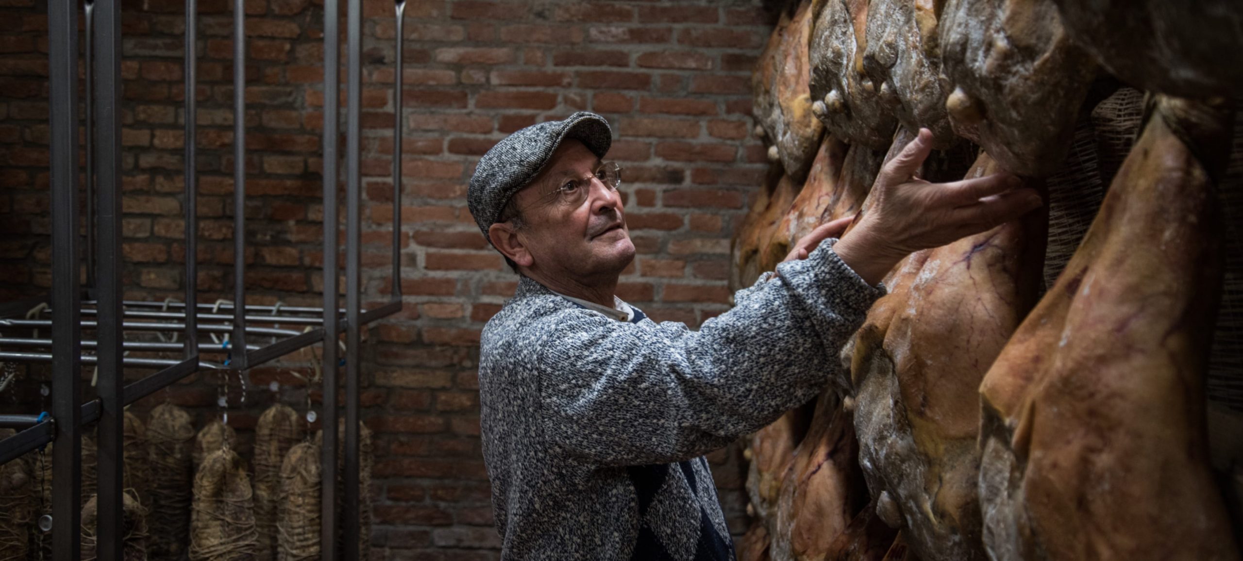Respected by Gaggenau, man checking the hanging hams of Salumi Bettella