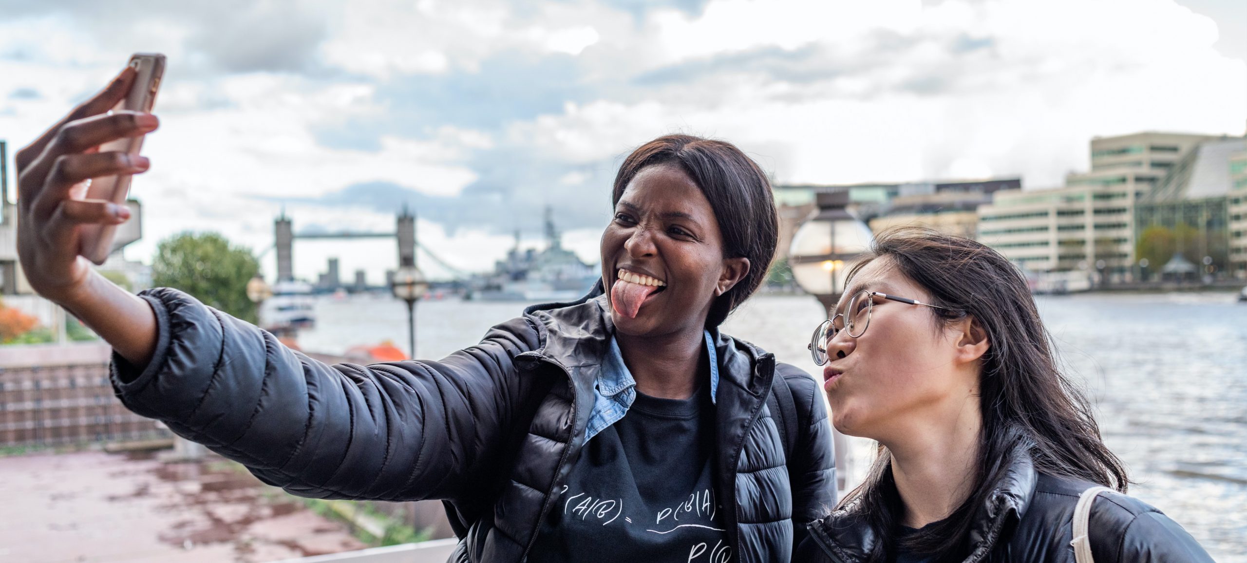 Bayes Business School, commisioned photography of students taking a selfie near London Bridge
